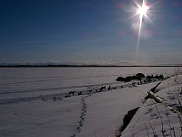 Camp on frozen river shore