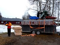 Packing food and wood wool on trailer