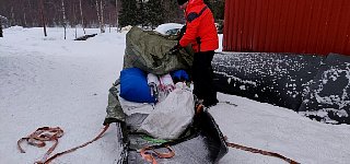 Snowmobile sled with dog food